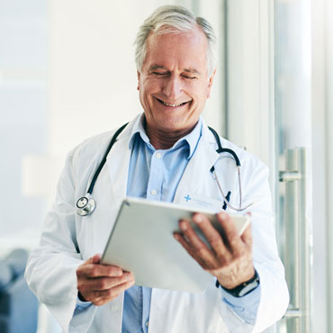 senior doctor viewing a tablet