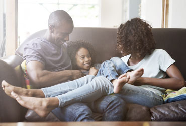 family of three relaxing in their living room
