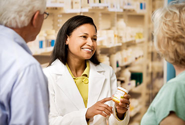 Pharmacist talking with customers
