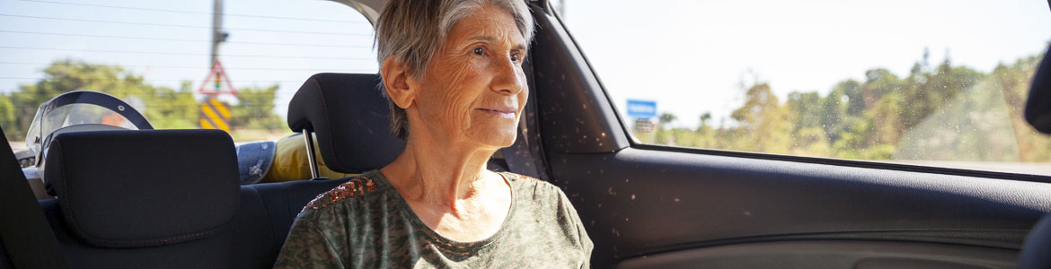 senior woman sitting in car