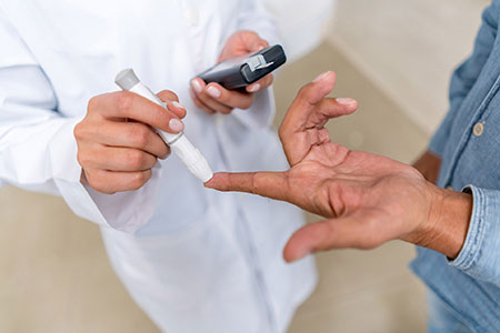 Doctor conducting a blood test for diabetes on a patient