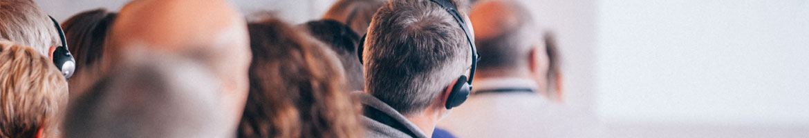 Man wearing headphones with a group of people