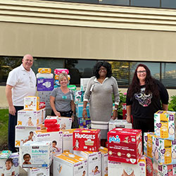 volunteers with diapers for donations