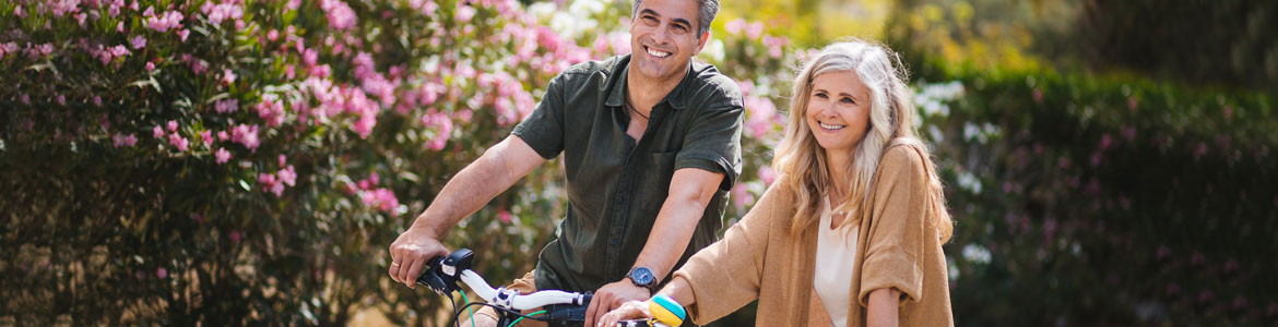 senior couple riding bikes outside together
