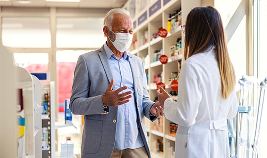 Pharmacist talking with customer